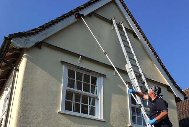 Scott Regan brushing cleaning fascia board
